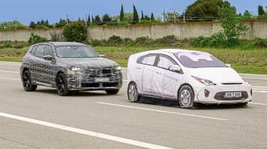 BMW X3 prototype (camouflaged) and dummy test car - front
